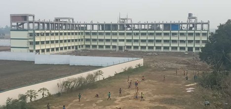 The multi-story St. Xavier's high school with children playing on the field