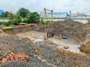 View of the pilings from the rooftop of the school. Over 1,000 pilings are being laid in the mud to strengthen the base of the new dining hall.